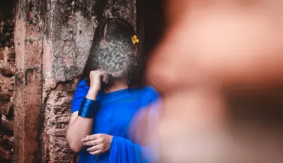 A woman posing for a camera in a natural setting